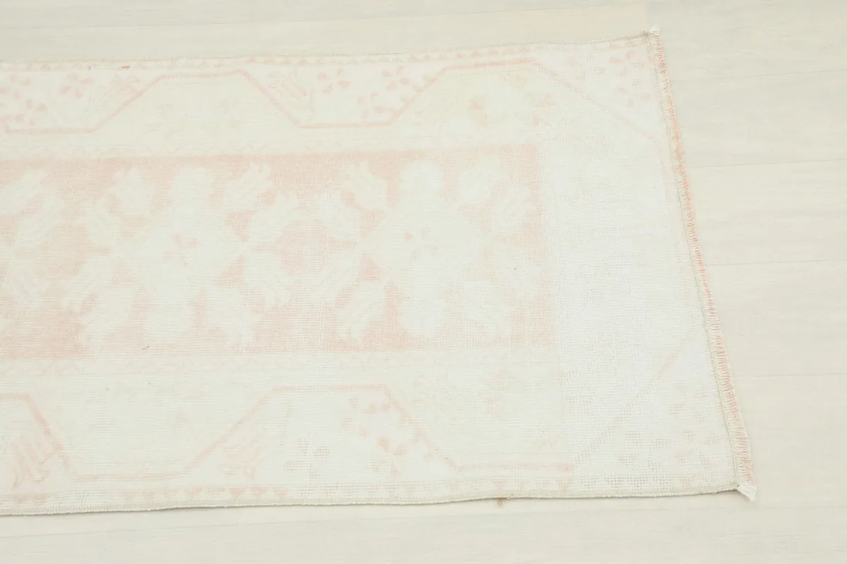 Close-up of the border and corner design on the vintage wool rug