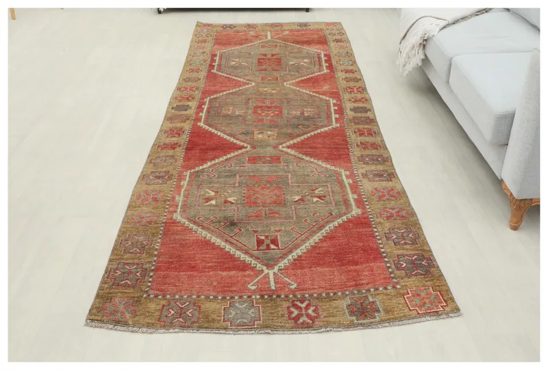 Full overhead view of the vintage Anatolian runner rug on a white floor