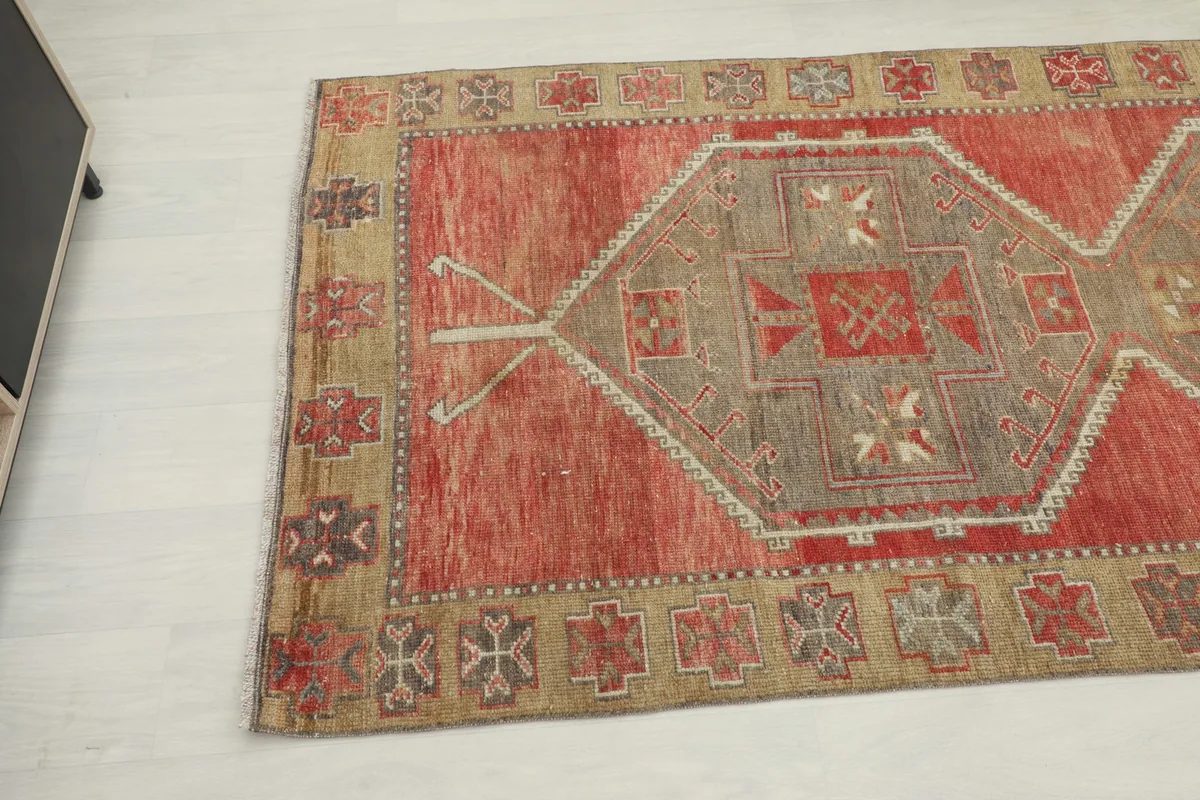 Angled view showing the central geometric medallion and border patterns of the rug