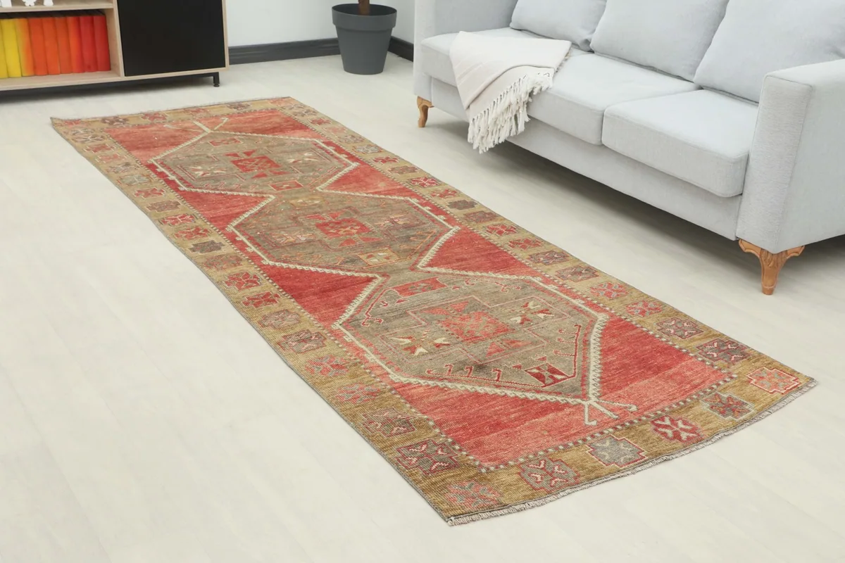 Angled view of the vintage runner rug extending across a room with light flooring