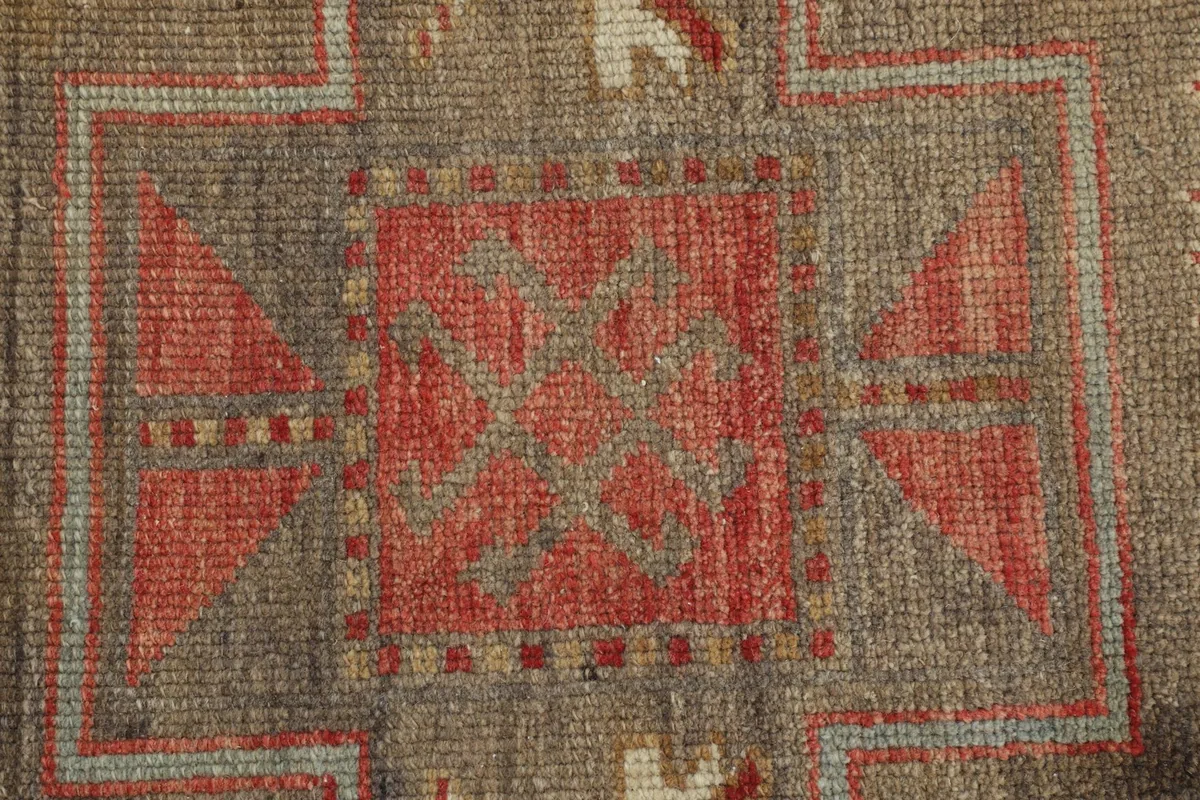 Close-up detail of the hand-knotted wool pile and intricate geometric design