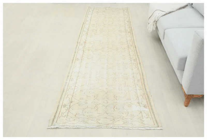 Full top view of the 3x10 cream vintage runner rug with geometric patterns on a white background.