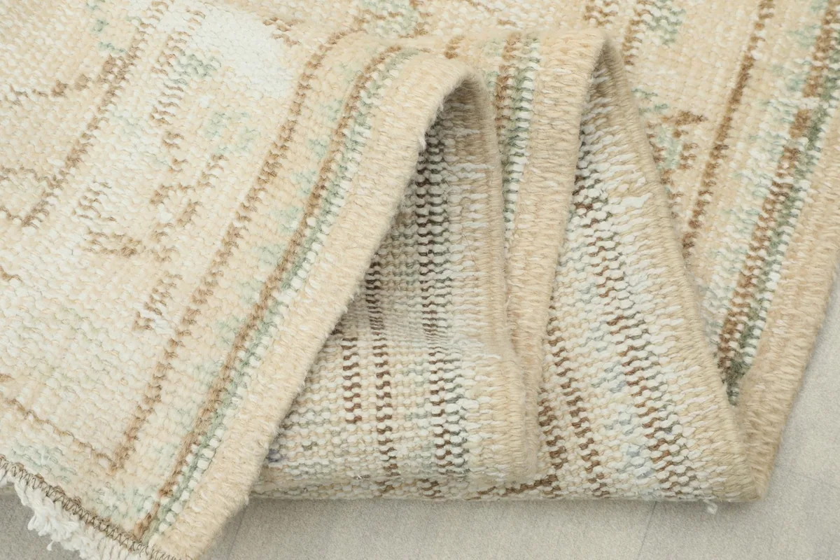 Close view of the low wool pile and the intricate knotting on the back of the vintage runner.