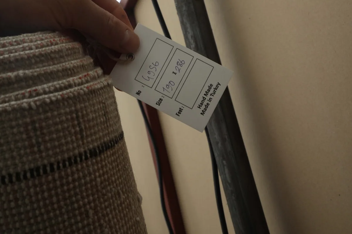 Hand-made in Turkey label attached to the rolled-up vintage rug