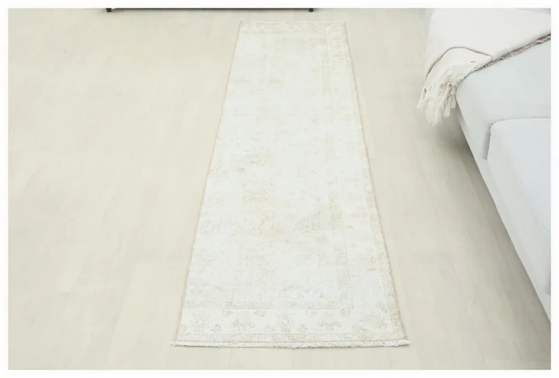 Full top view of the 2'1" x 8'7" ivory and beige Anatolian runner rug on a white background.