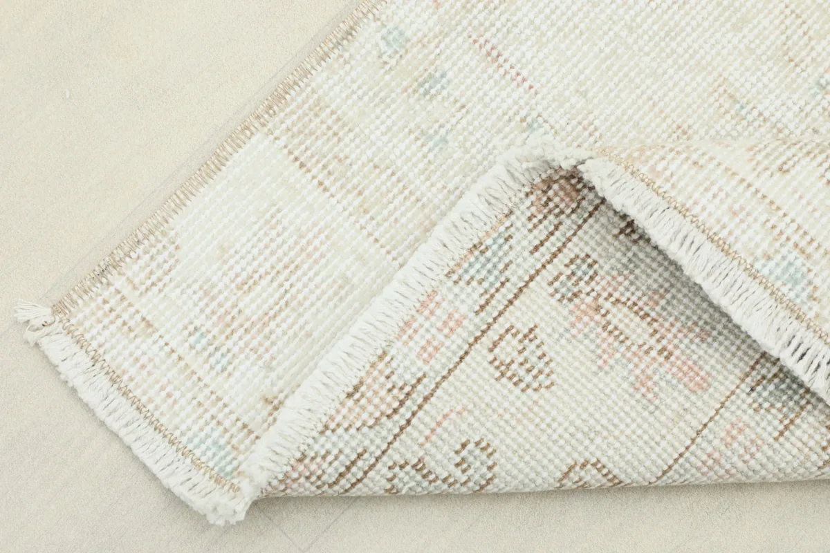 View of the back of the rug, revealing the cotton foundation and hand-knotted construction.