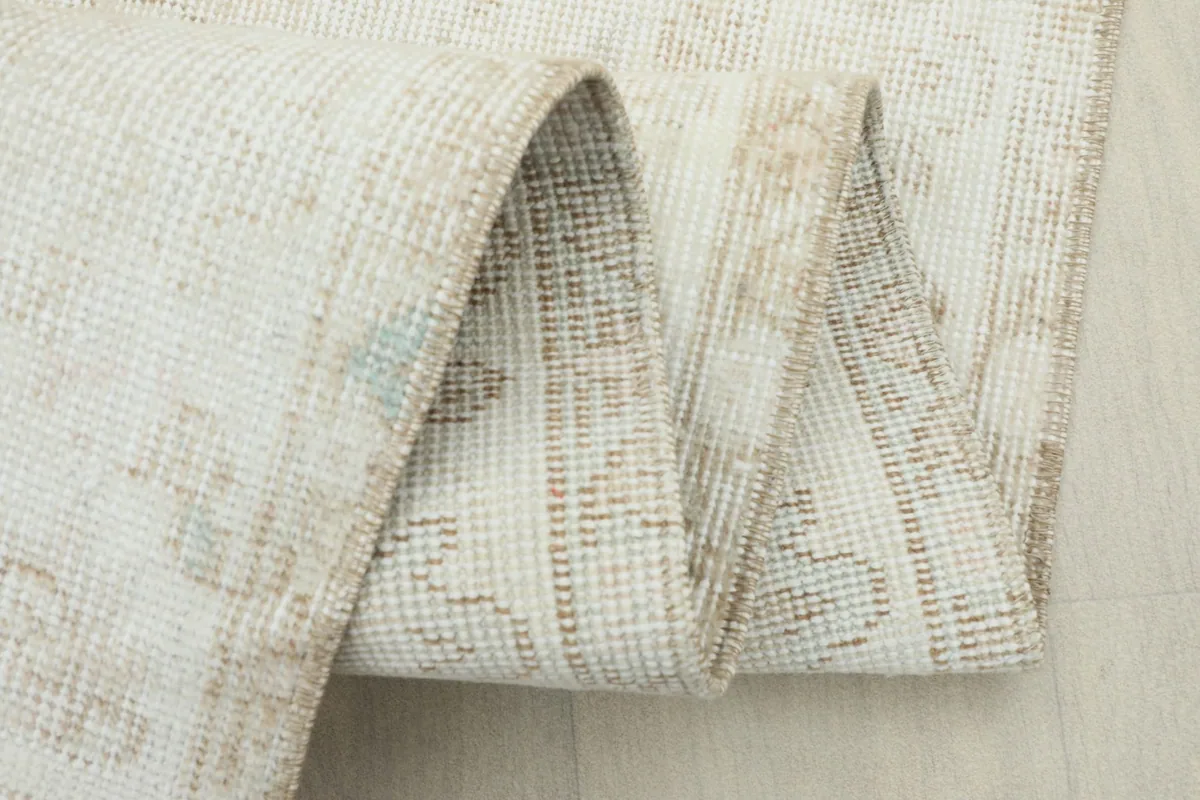 Close-up of the rug in a rolled state, highlighting the weave and texture.
