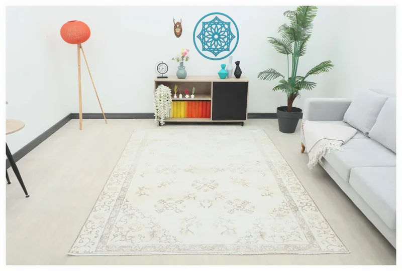 Full top view of the ivory beige floral vintage Anatolian rug on a white background