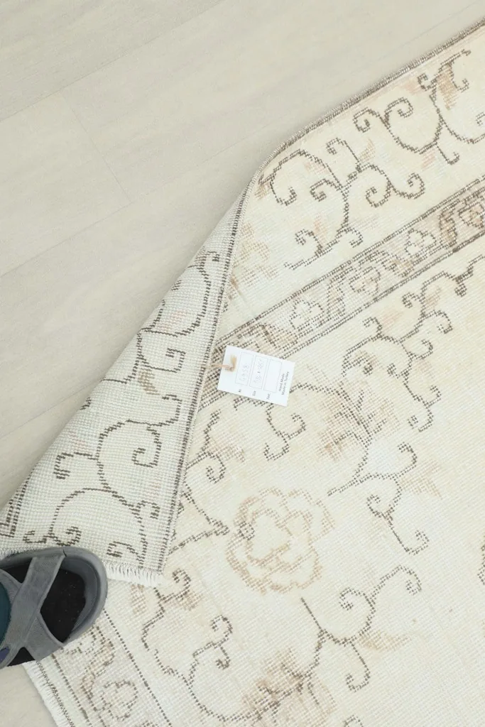 Overhead view of the back of the rug, revealing the hand-knotted cotton foundation
