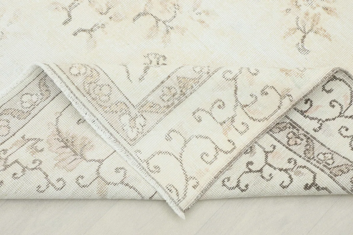 Folded corner of the rug showing the reverse side and knotting