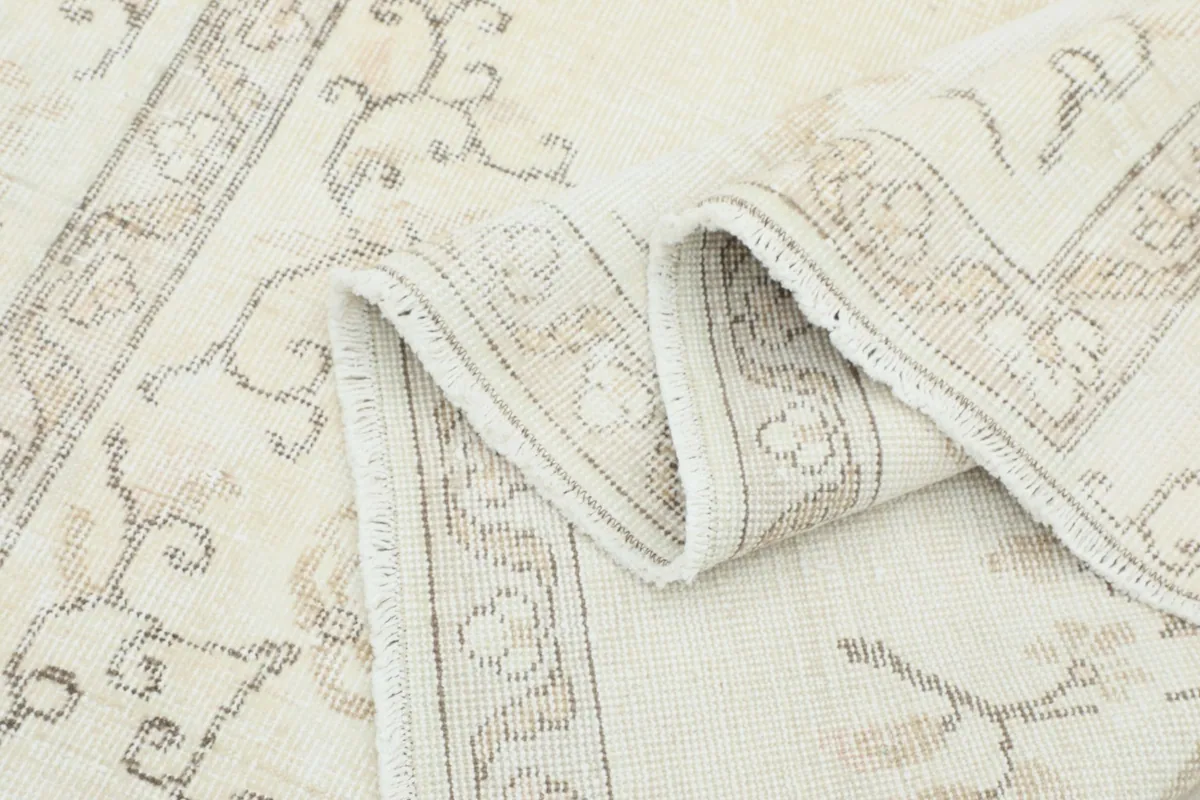 Another view of the folded rug, highlighting the texture and border