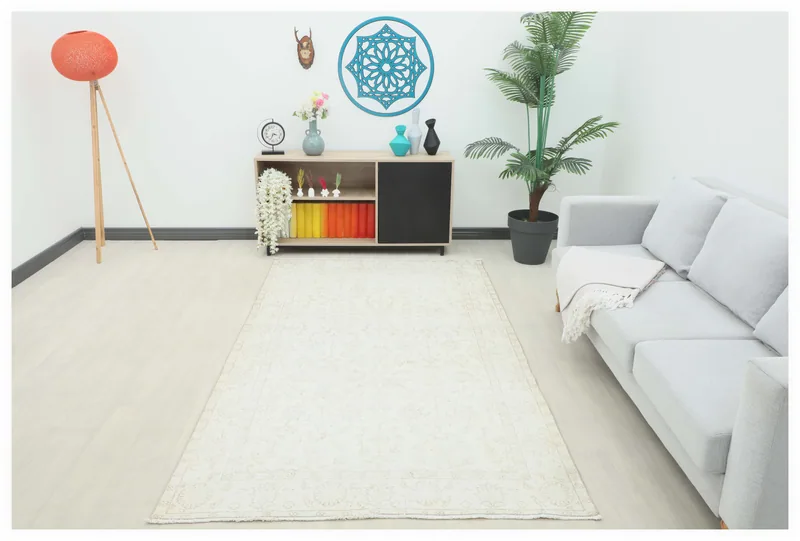 Full top view of the cream and tan floral Anatolian area rug on a white background.