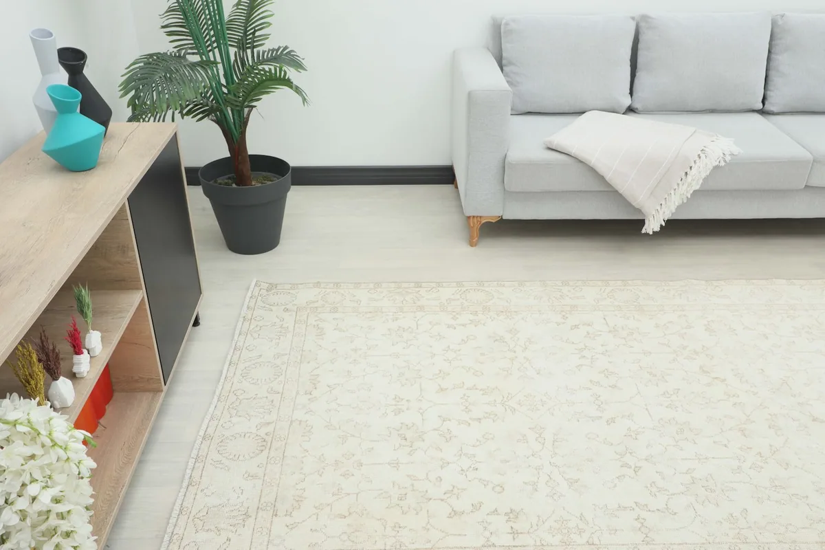 Room view from a different angle, showing the cream rug complementing modern furniture.
