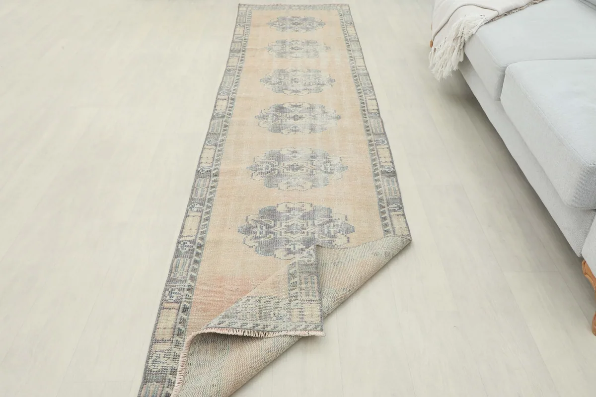 Runner rug partially folded, illustrating its flexibility and the back of the rug.