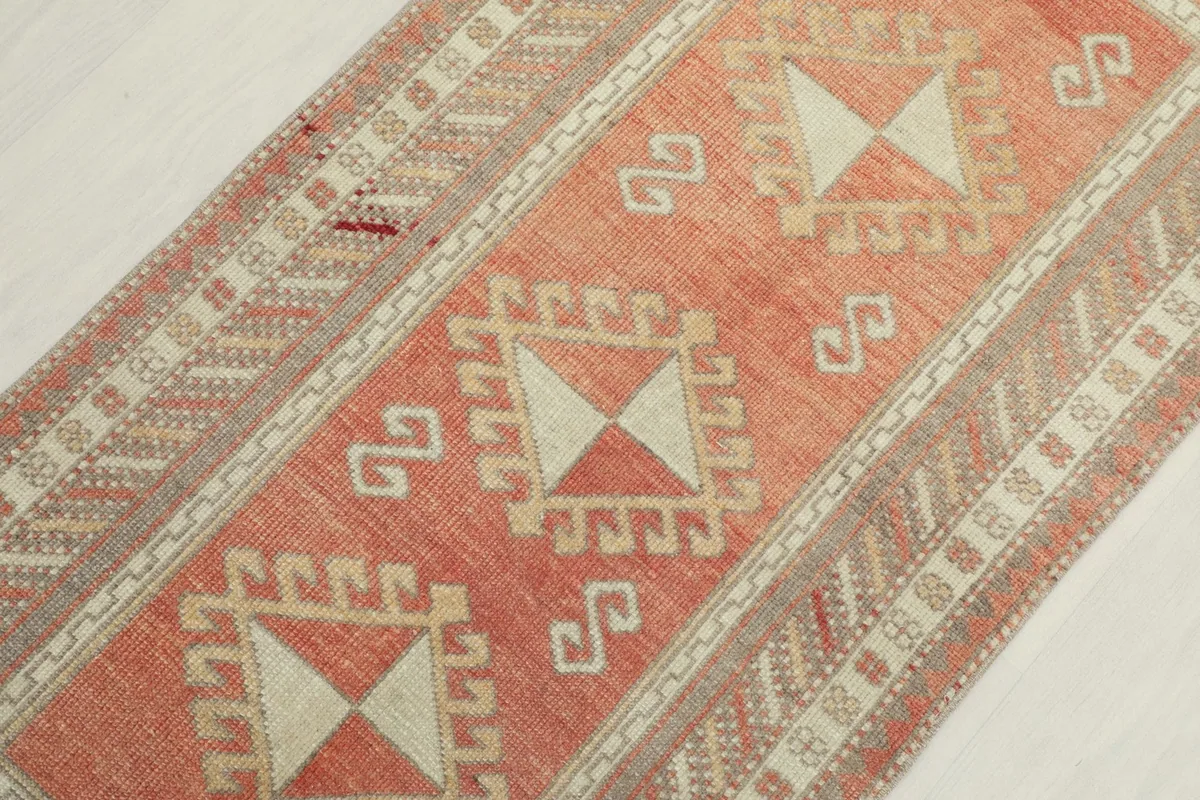 Overhead angled view focusing on the central geometric motifs and the surrounding rust field