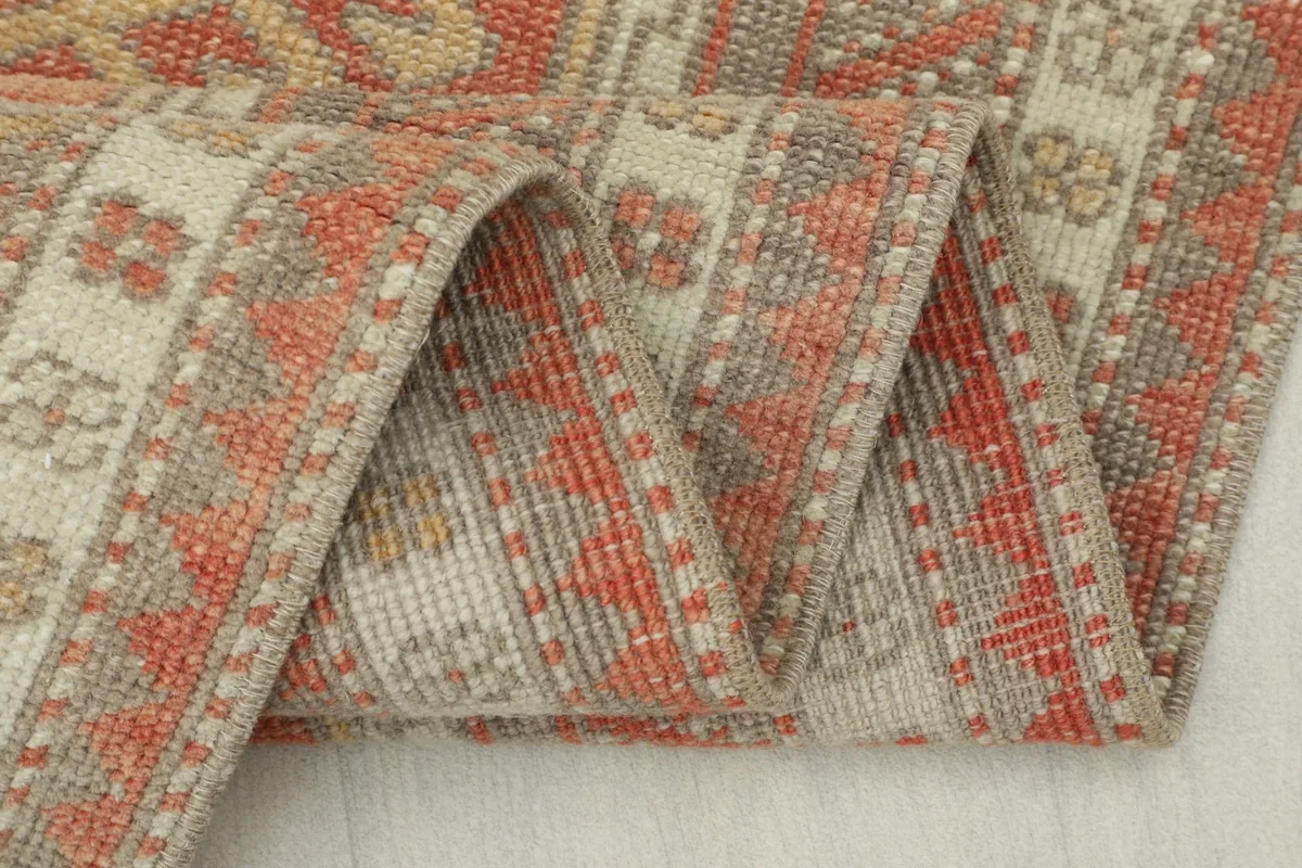Close-up of the rug's reverse side, showing the tightly woven cotton foundation and knotting
