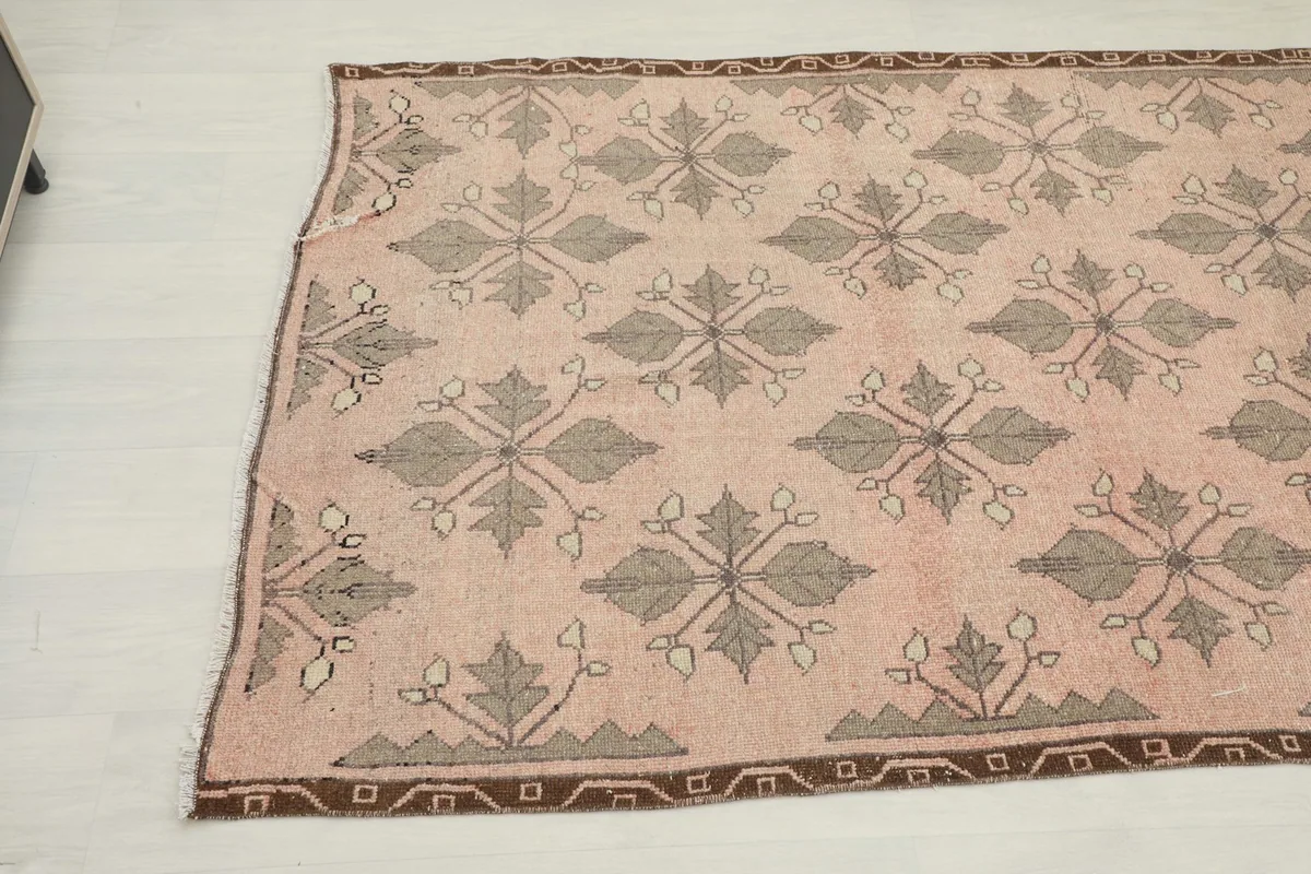Angled view of the runner rug, highlighting the repeating geometric patterns and border design