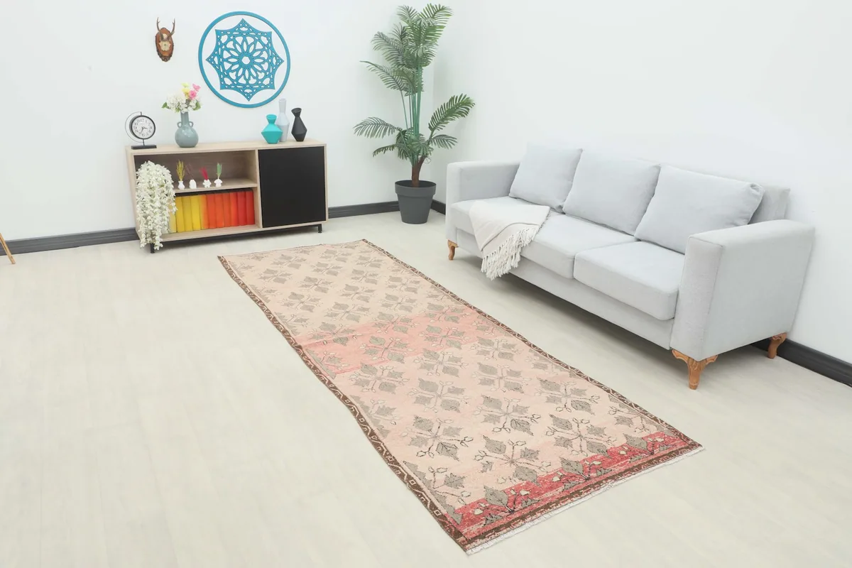 Vintage Anatolian runner rug displayed in a bright room setting with a sofa and console