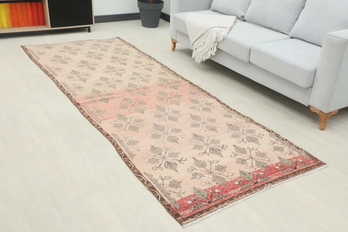 Overhead view of the rose and gray geometric runner rug in a modern living space