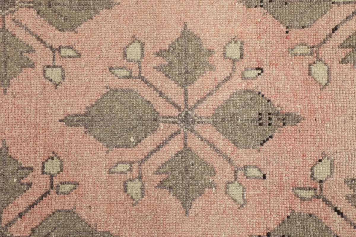 Macro detail of the hand-knotted wool pile and individual geometric design elements