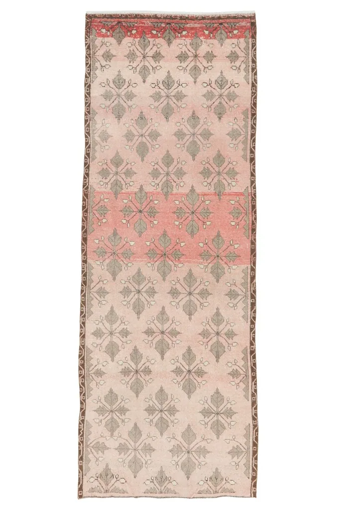 Full overhead view of the vintage runner rug, clearly showing the rose and gray pattern variation