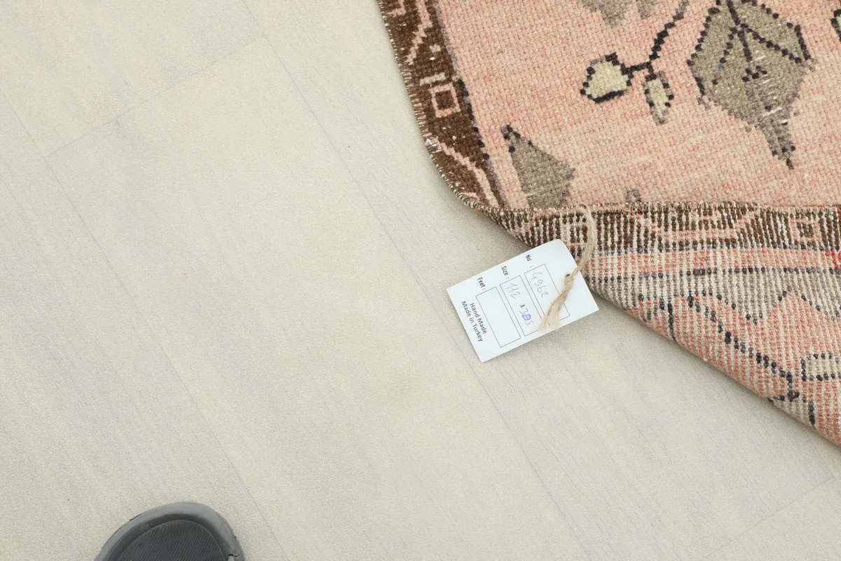 Corner of the runner rug with a product tag visible on the floor