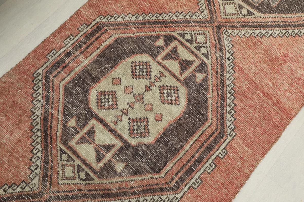 Detailed view of the central medallion's beige and brown geometric design
