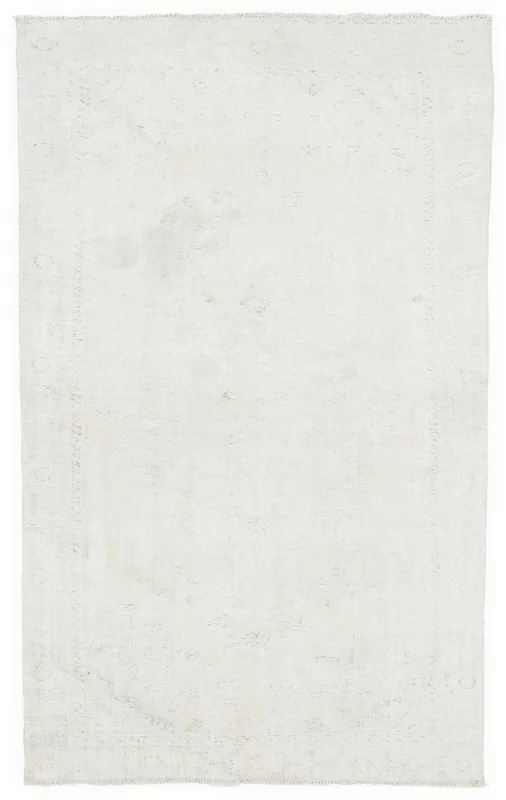 Full overhead view of the 5'3" x 8'11" ivory vintage Anatolian area rug on a white background.