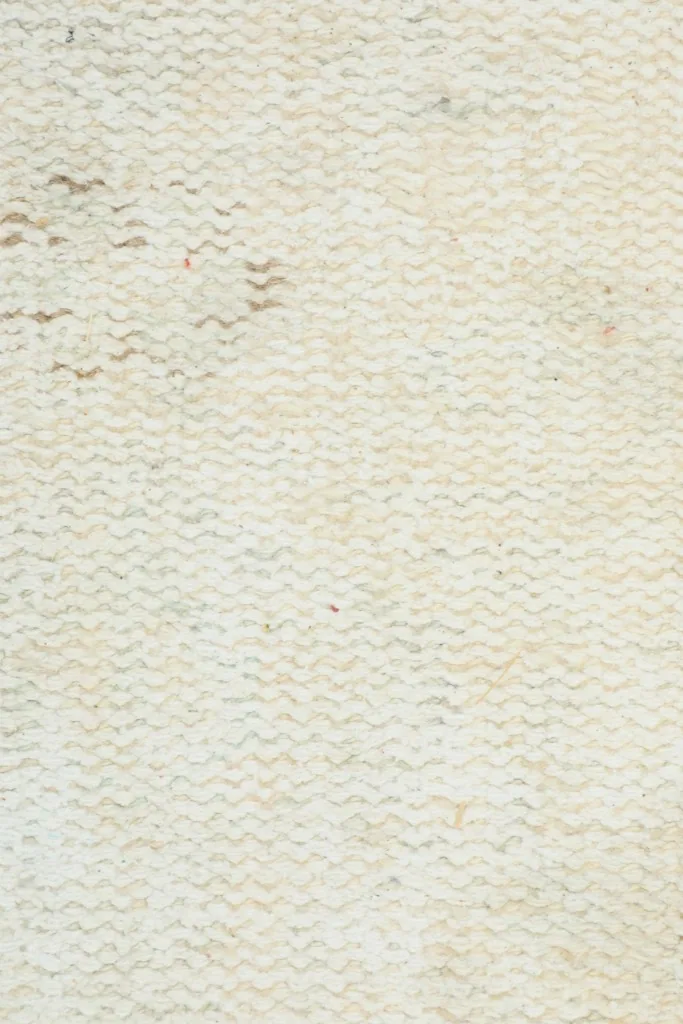 Underside view of the hand-knotted cotton foundation, showing the intricate weave of the rug.