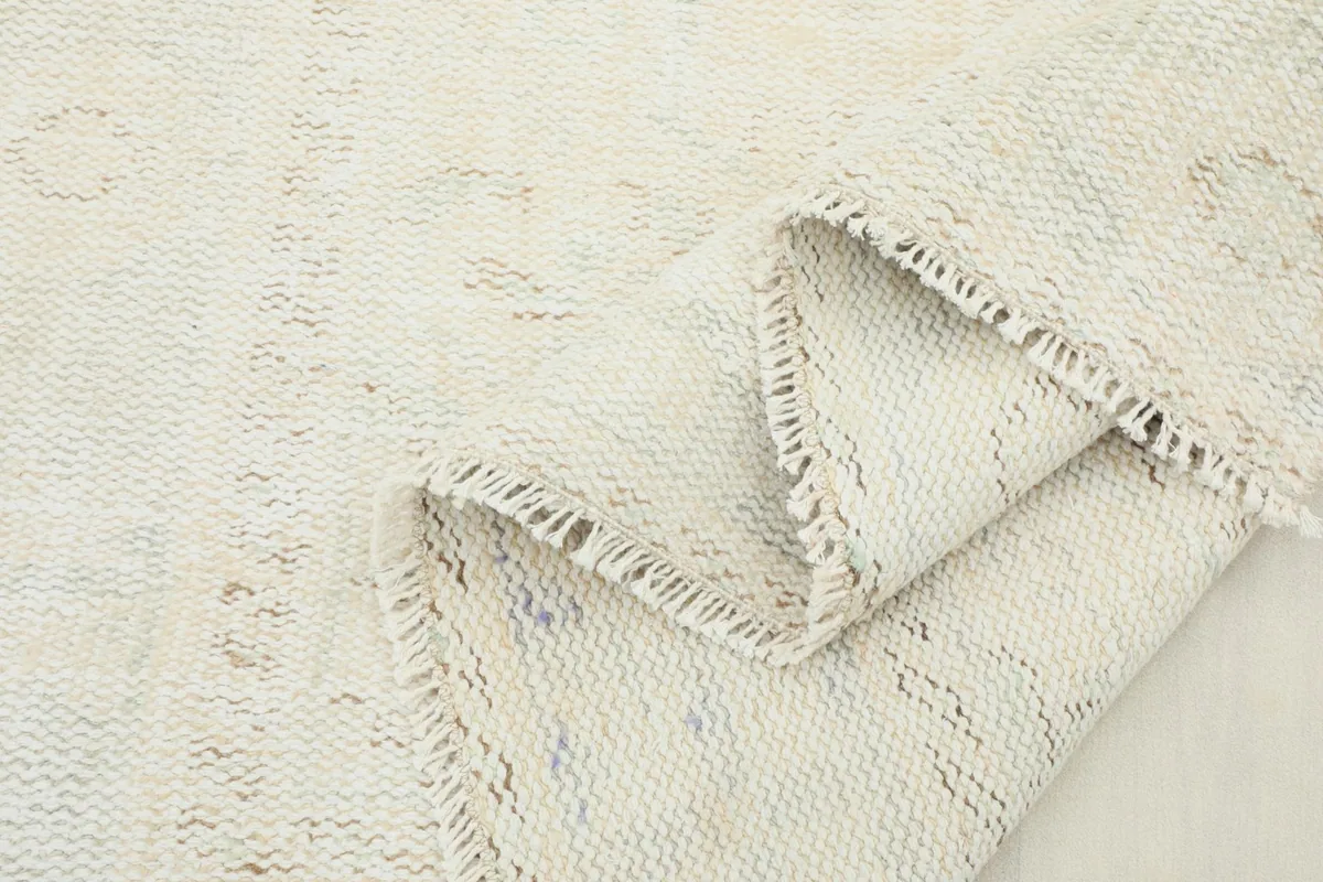 Another view of the rug folded, highlighting the texture of the pile and the craftsmanship.