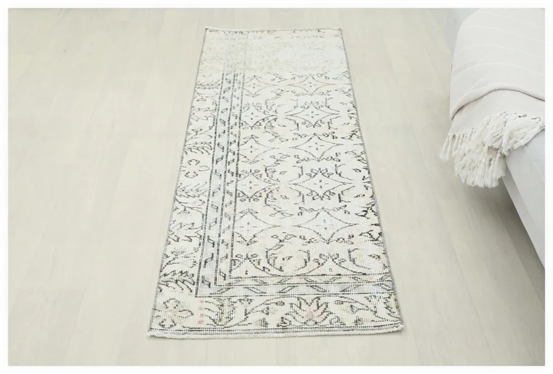 Full overhead view of the 2'0" x 6'0" cream and charcoal geometric floral runner rug on a white background.