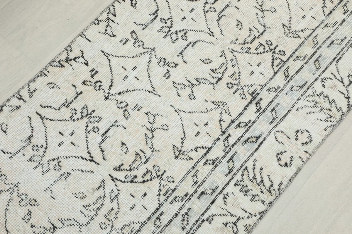 Detail view of the central cream field with charcoal geometric and floral patterns.