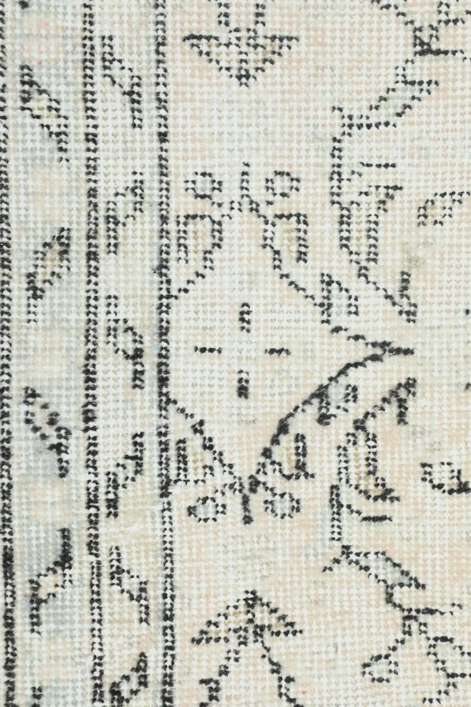 Close-up of the rug's reverse side, showing the hand-knotted wool pile on cotton foundation.