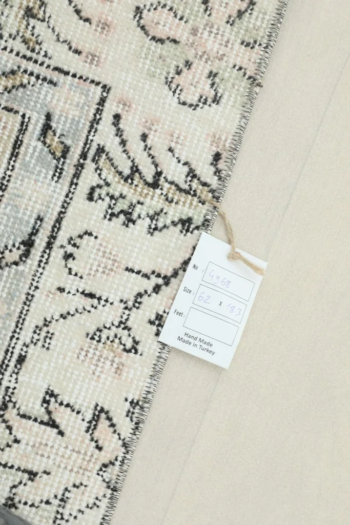 Close-up of the rug with its product tag, showing details and origin.