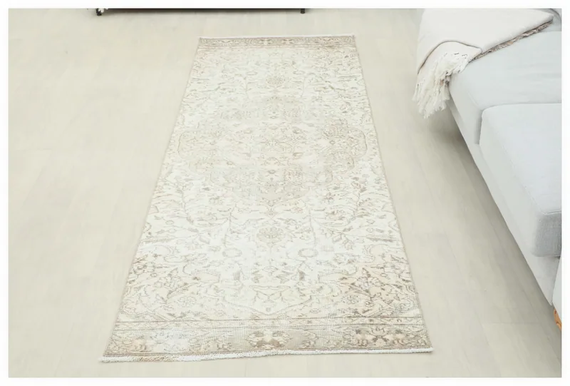 Full overhead view of the cream and gray vintage Anatolian runner rug.