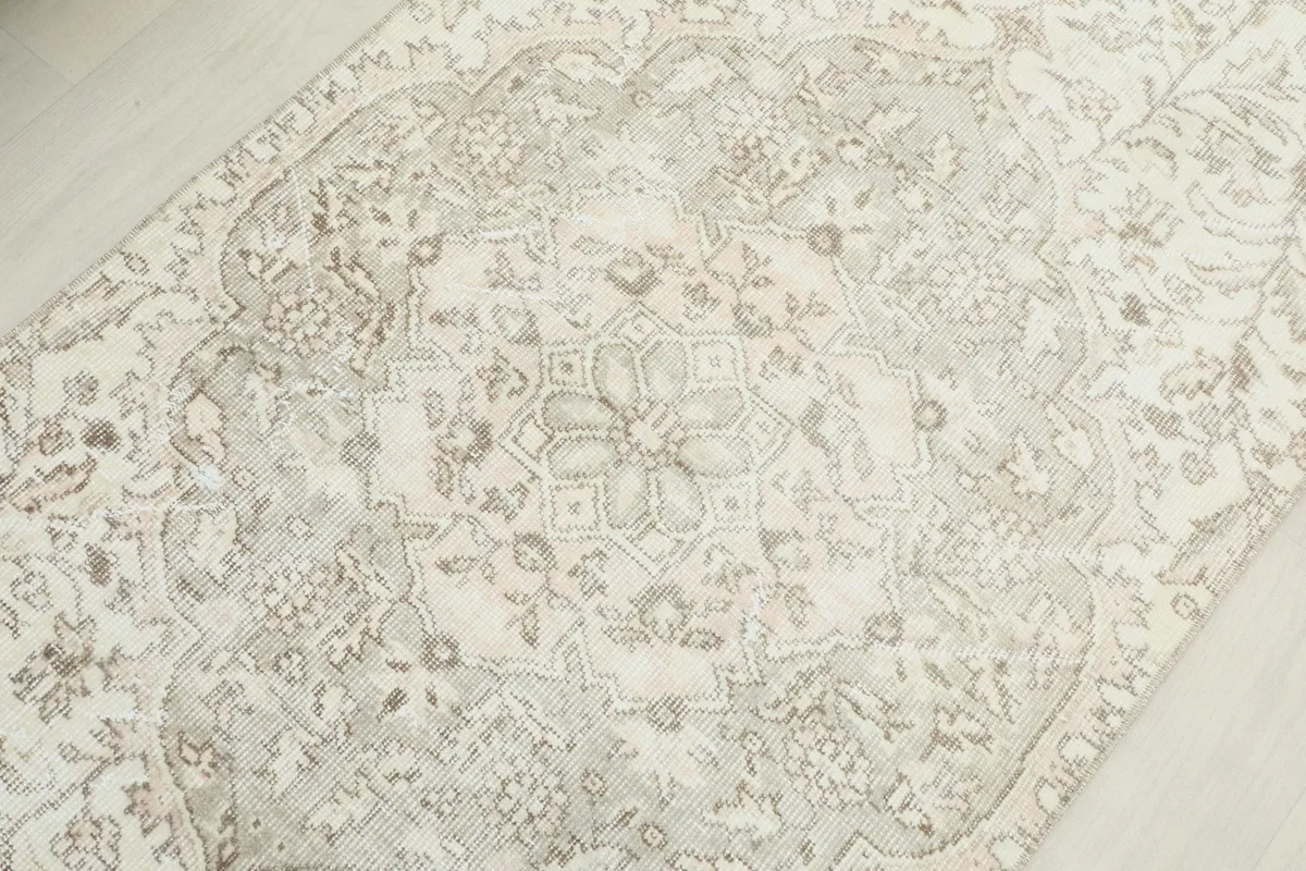 Overhead close-up of the central medallion pattern and surrounding faded floral details.