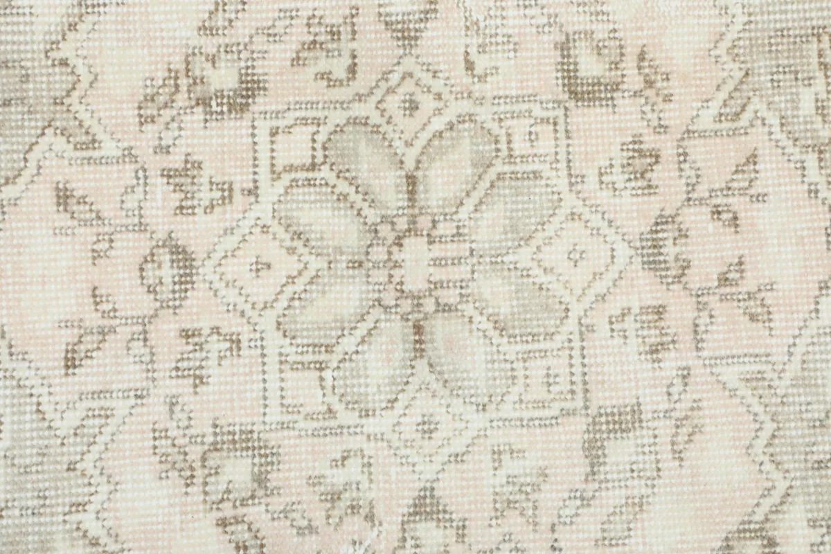 Extreme close-up of the low wool pile, showing the hand-knotted texture and faded colors.