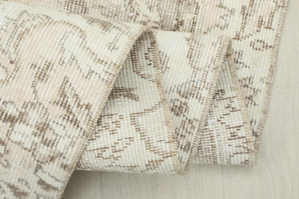 Close-up of the rug's reverse side, showing the cotton foundation and knotting.