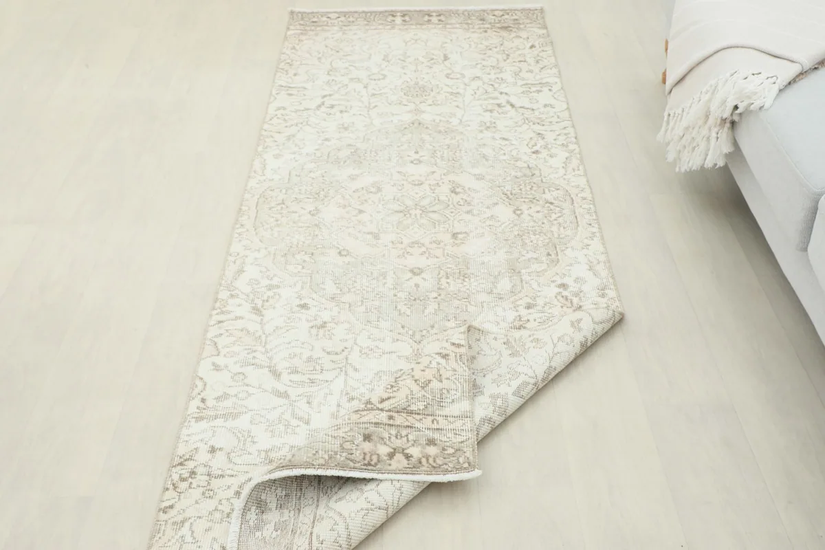 Rug partially folded, demonstrating its flexibility and the overall pattern.