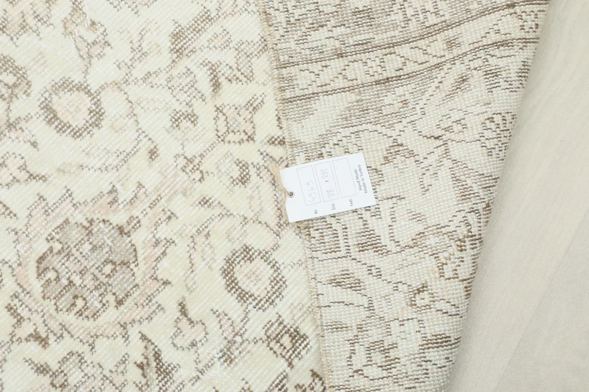 View of the rug with a tag, highlighting the overall pattern and texture.