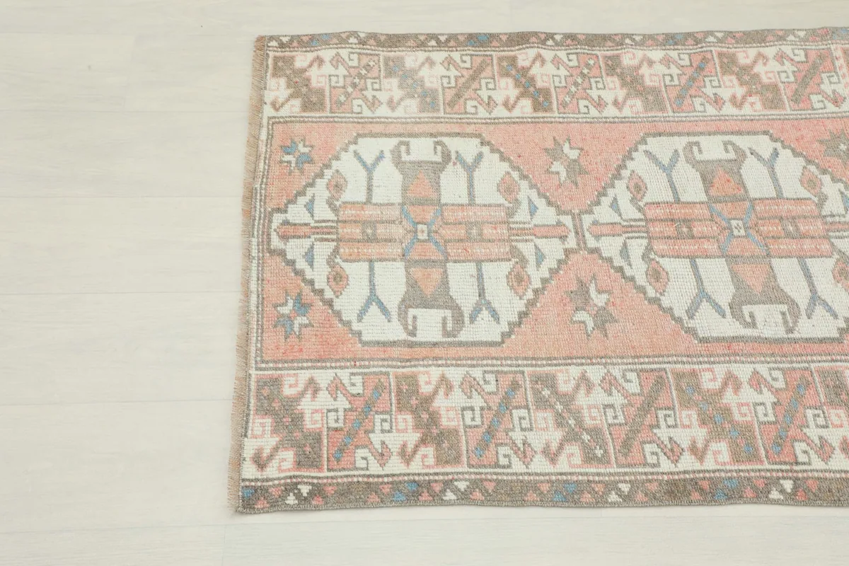 Another close-up detail highlighting the tribal motifs and color variations in the vintage rug.