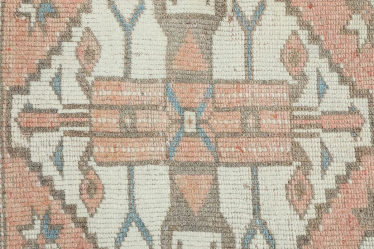Tight detail shot of the hand-knotted wool pile, showing individual knots and color blend.