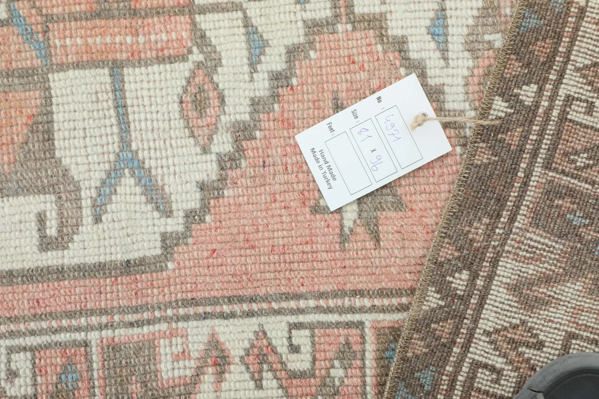 Close-up of the rug's texture and pattern with a product information card visible.