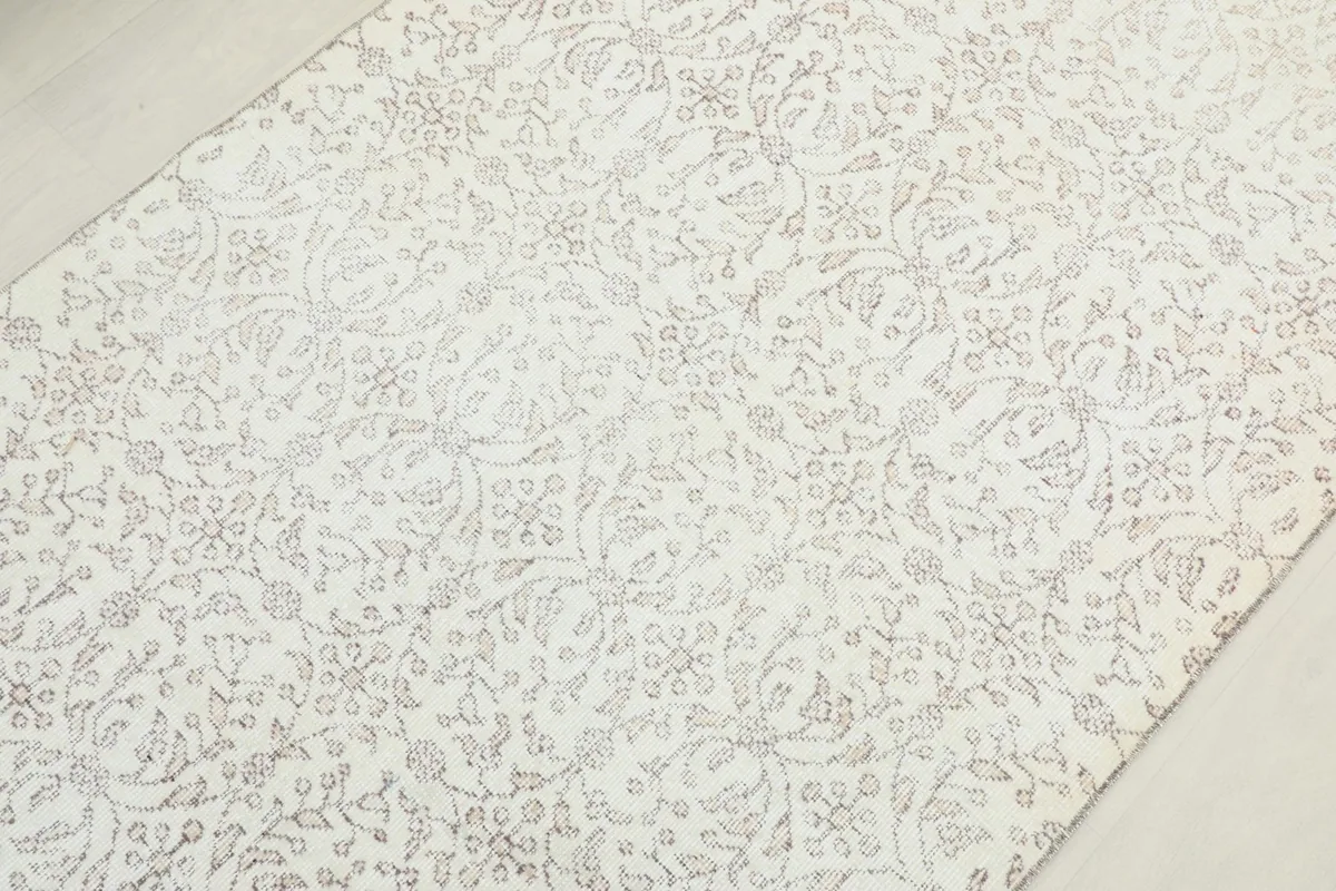 Overhead view focusing on the central part of the rug, showing the consistent floral design.