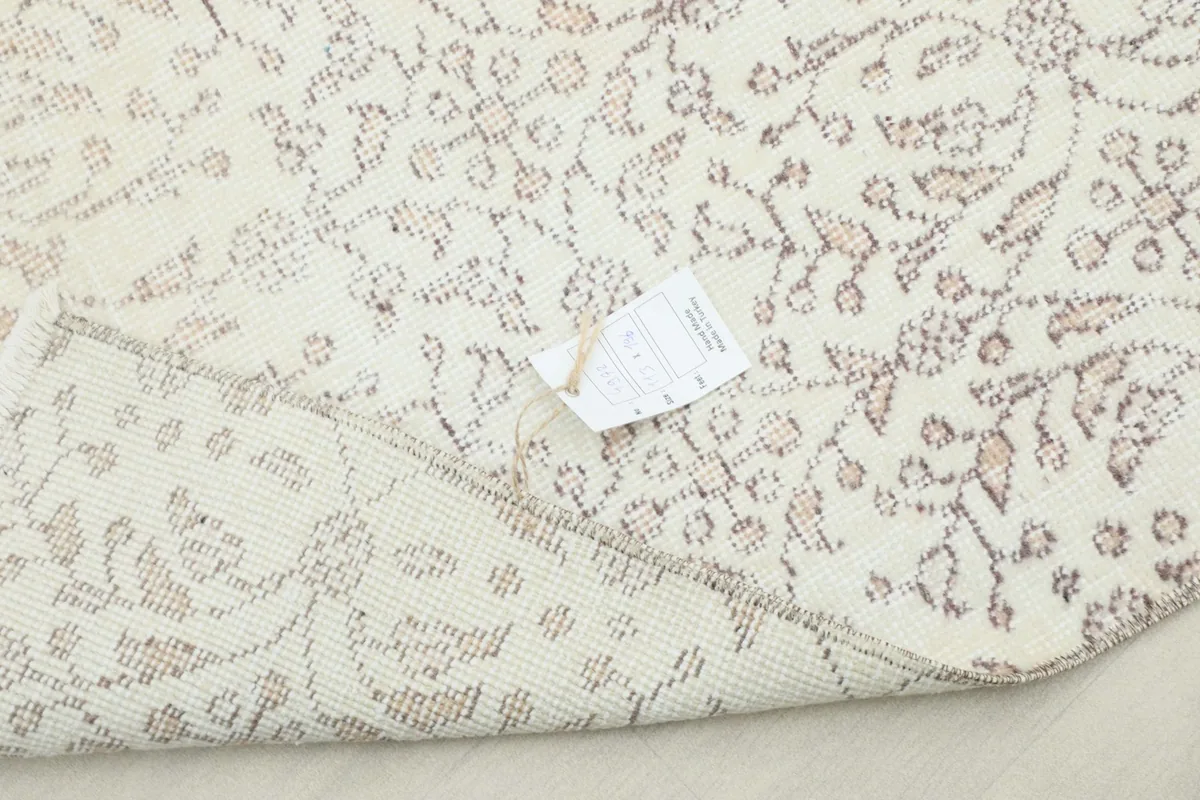 Rug with a tag, providing a glimpse of product information while highlighting the pattern.