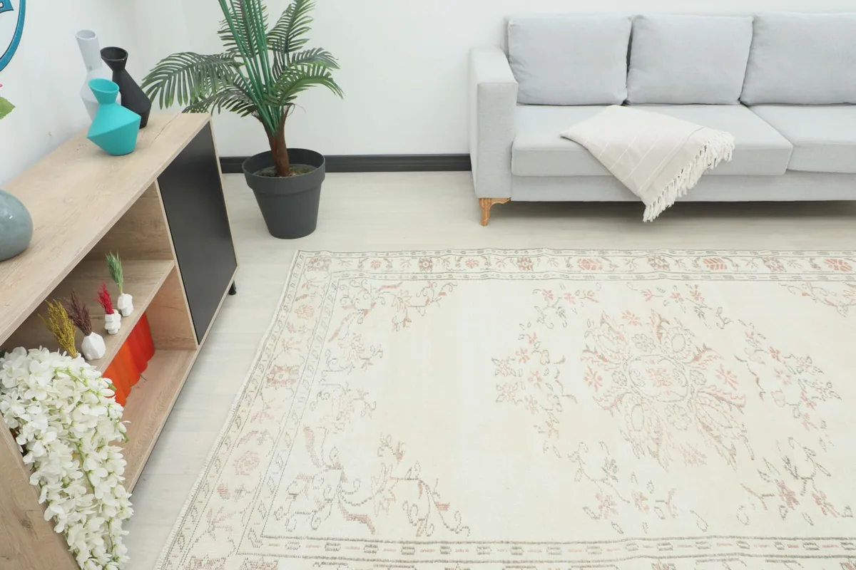 Overhead view of the rug in a room, highlighting its placement in front of a light gray sofa.