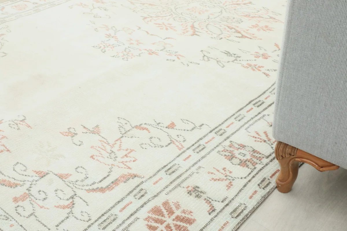 Rug placed next to a sofa, demonstrating its size and how it complements modern furniture.