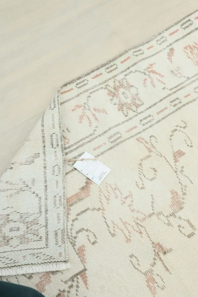View of the rug's reverse side, showing the tight hand-knotting and cotton foundation.