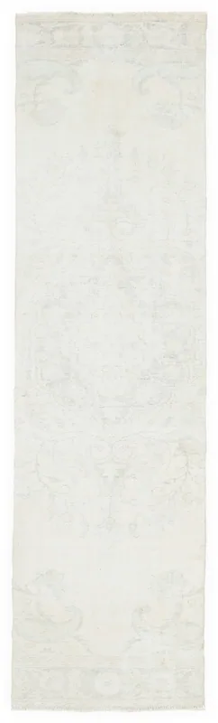 Full top view of the 2'9" x 10'1" cream vintage runner rug with faded blue and green patterns