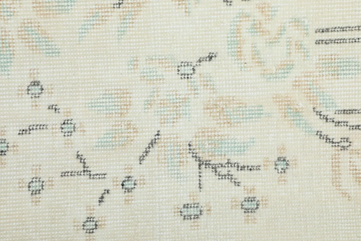 Macro view of the hand-knotted wool pile showing the intricate details of the pattern